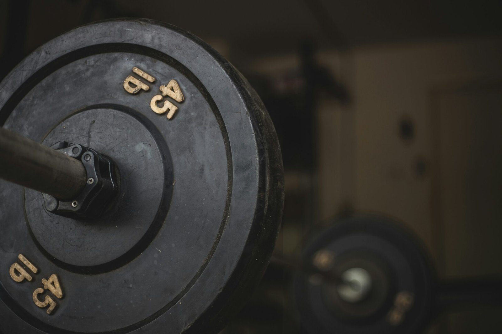 black and gray dumbbell on black surface